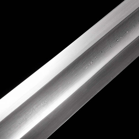 Close up of layered Damascus steel blade showing natural wave pattern on Conan movie sword replica