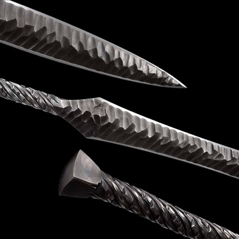 Close up detail of folded steel blade showing layered grain on European medieval spear sword