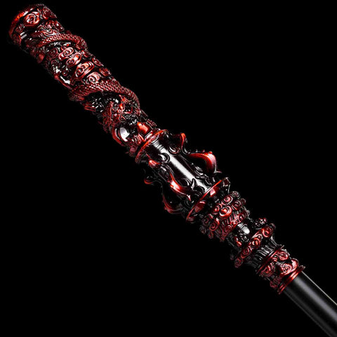 Close-up of red and black alloy sculpted end fittings of Ruyi Jingu Bang replica staff